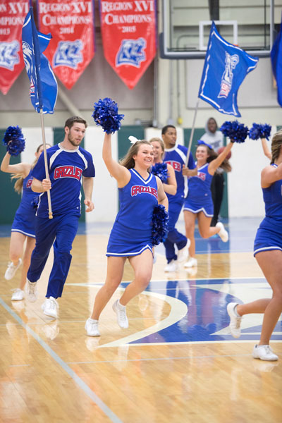 GRIZZLY CHEER TEAM members lead the basketball team onto the court at the 2017 homecoming game. (Missouri State-West Plains Photo)