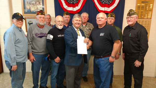 MEMBERS OF THE JOHN T. KIRK VFW Post 1828 in West Plains recently donated $1,000 and penned a letter in support of the Veterans Center at Missouri State University-West Plains. The center, which provides a variety of services to support veteran students, will be relocated from the Garnett Library to Hass-Darr Hall, the former post office building on Garfield Avenue, once renovations on the facility are complete. University officials said they would welcome donations and letters of support from other veterans organizations as they work toward the $250,000 goal for the center. Call 417-255-7240 for more information. On hand for the donation were, front row from left, post members Jime Ramsey Gene Jamtgarrd and Doyle Bradshaw; Missouri State-West Plains Chancellor Drew Bennett; post commander Danny Brown and member Joe Bean. Back row: Post members David Harris, Robert Holt, Jerry Lair and Robert Lee. (Missouri State-West Plains Photo)