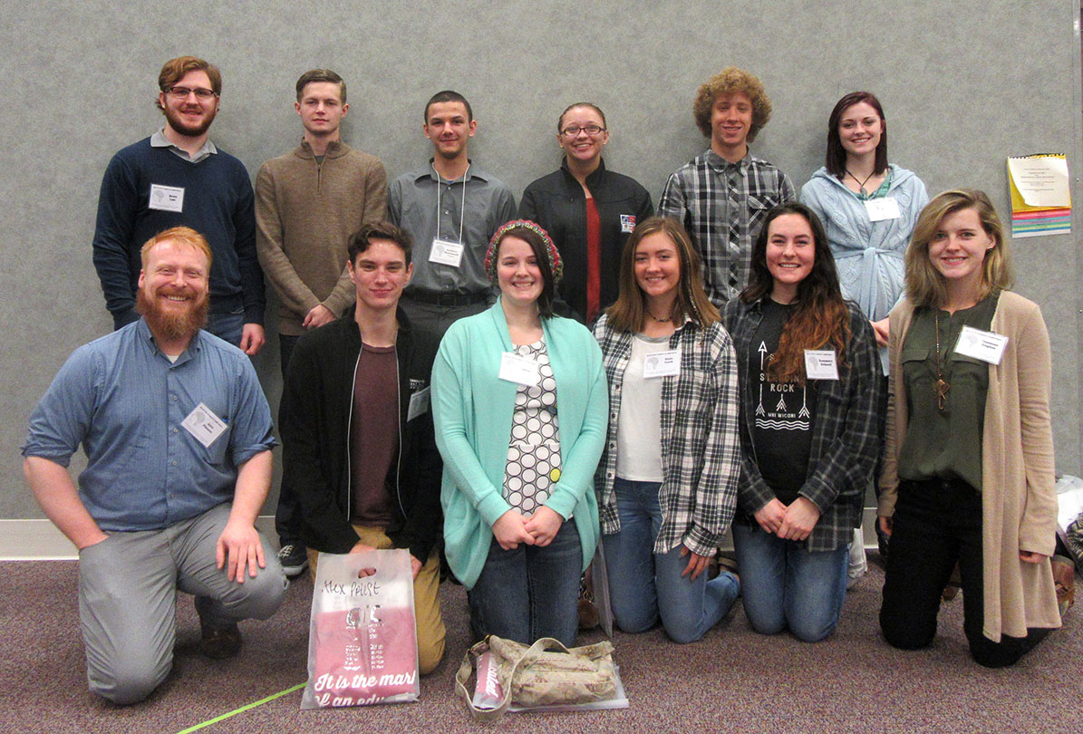 ELEVEN STUDENTS in the William and Virginia Darr Honors Program at Missouri State University-West Plains attended the annual Ozarks Technical Community College Honors Conference March 25 in Springfield. The conference covers an eclectic spectrum of student- and faculty-led panels on such topics as the sciences, humanities and service learning, among others. For many two-year undergraduate students, the conference is a rare opportunity to experience and participate in an academic conference, Darr Honors Program Director Alex Pinnon said. In fact, Darr Honors student Anthony MacConnell, West Plains, presented a panel entitled “The Argument for Internal Propulsion.” Calling it a “highlight of the academic year” for his students, Pinnon said the event gives students the opportunity to network with four-year schools that offer honors programs, learn about topics unfamiliar to their studies, “and they just have an all-around blast.” Front row from left are Pinnon and students Alex Priest and Michelle Oliver, both of West Plains; Blair Cook, Plato; Rosemary Driscoll, Brandsville; and Shannon Hughes, West Plains. Back row: Brett Lair, West Plains; Sage Clunn, Ava; MacConnell, Whitney Brooks and Weston Phipps, all of West Plains; and Destiny Johnson, Viola, Ark. (Photo provided)