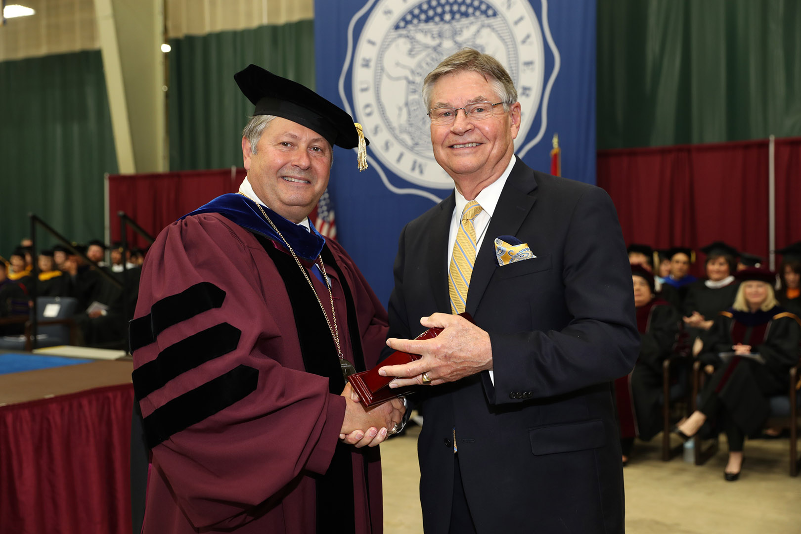 LONG-TIME WEST PLAINS BUSINESSMAN and community leader Jay Padgett, right, received the Granvil Vaughan Founder’s Award Saturday, May 20, during Missouri State University-West Plains’ commencement ceremony at the West Plains Civic Center arena. He received his award from Missouri State-West Plains Chancellor Drew Bennett. (Missouri State-West Plains)