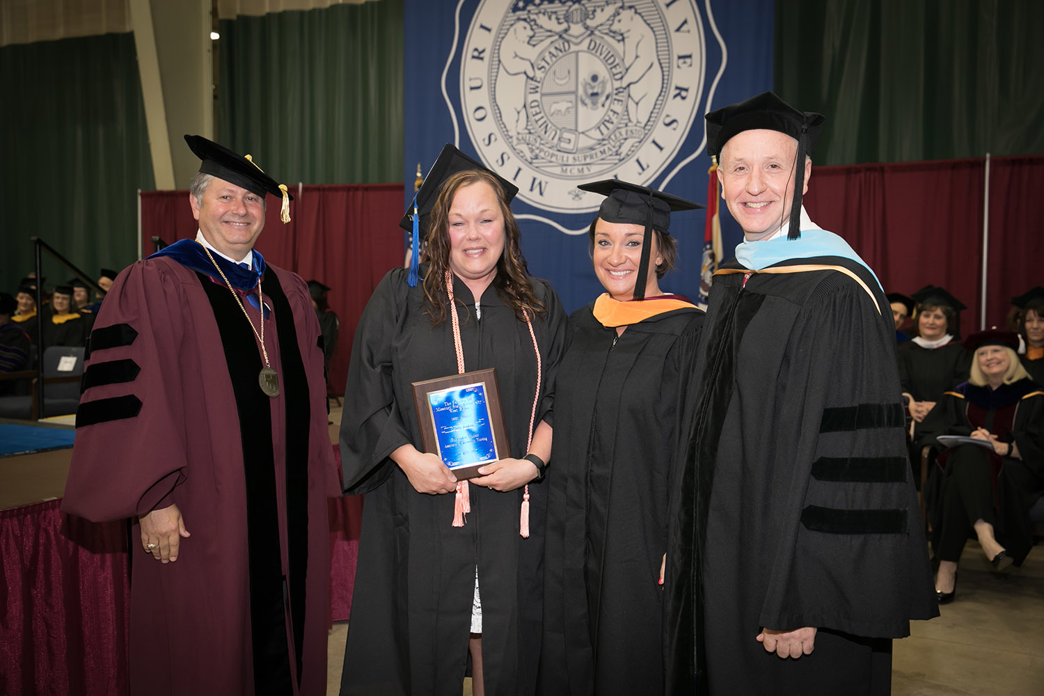 LAURA JENKINS, West Plains, received the Outstanding Student Award for Associate of Science in Nursing degree graduates at Missouri State University-West Plains’ commencement ceremonies Saturday, May 20, at the West Plains Civic Center. The award recognizes a graduate from ASN program who exhibits academic achievement and honesty, class participation, conscientiousness, university and community service, and outstanding clinical performance. From left above are Missouri State-West Plains Chancellor Drew Bennett, Jenkins, Director of Nursing Amy Ackerson and Dean of Academic Affairs Dr. Dennis Lancaster. (Missouri State-West Plains Photo)