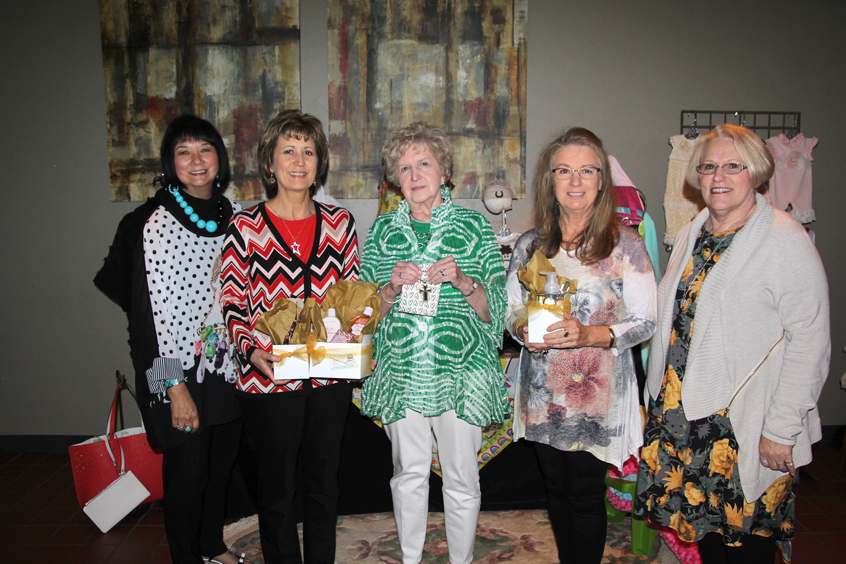 THREE WEST PLAINS RESIDENTS won giveaways at the Friends of the Garnett Library’s annual spring fashion show fundraiser Friday, April 28, at the West Plains Country Club, which was hosted by The Kloz Klozet and Cleea’s At Home Market. Beverly Linson, West Plains, received a Brighton cross key chain from The Kloz Klozet; Jan Greiner, West Plains, received a Michel Soaps bath and body gift pack from Cleea’s At Home Market; and Cheryl Caldwell, West Plains, received a Brighton star necklace from The Kloz Klozet and a Crabtree & Evelyn gift pack from Cleea’s At Home Market. From left are Florence James, owner of The Kloz Klozet; Caldwell; Linson; Greiner; and Cleea Walls, owner of Cleea’s At Home Market. Proceeds from the event will go toward creating a “huddle space” for group study in the library. (Missouri State-West Plains Photo)