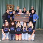 A TOTAL OF $1,035 was raised for the Missouri State University-West Plains Grizzly Cheer team during a customer appreciation day and fundraiser hosted by the Duke Boyz on July 15. In addition to hosting rides and food to celebrate three years in business, organizers with the Duke Boyz donated 75 percent of the proceeds from car washes conducted by the cheer team and T-shirt sales as part of the event. The money will be used to purchase new uniforms. On hand for the check presentation were, front row from left, cheer team members Tori Terrill, Mtn. View; Carlea Badolian, West Plains; Alexis Fuwell, Mountain Grove; Neely Gobel, West Plains; and Felicity Snelling, Licking. Second row: Assistant Coach Keena Simpson; cheer team member Makayla Koon, West Plains; Duke Boyz owner Kyle Duke; cheer team member Karli Habel, Spokane; and cheer team coordinator Rachel Peterson. Back row: Grizz (aka Robyn Rex, Spokane); and cheer team members Zachary Cook and Brandon Owens, both of West Plains; and Jayse Muncy, Dadeville. (Missouri State-West Plains Photo).