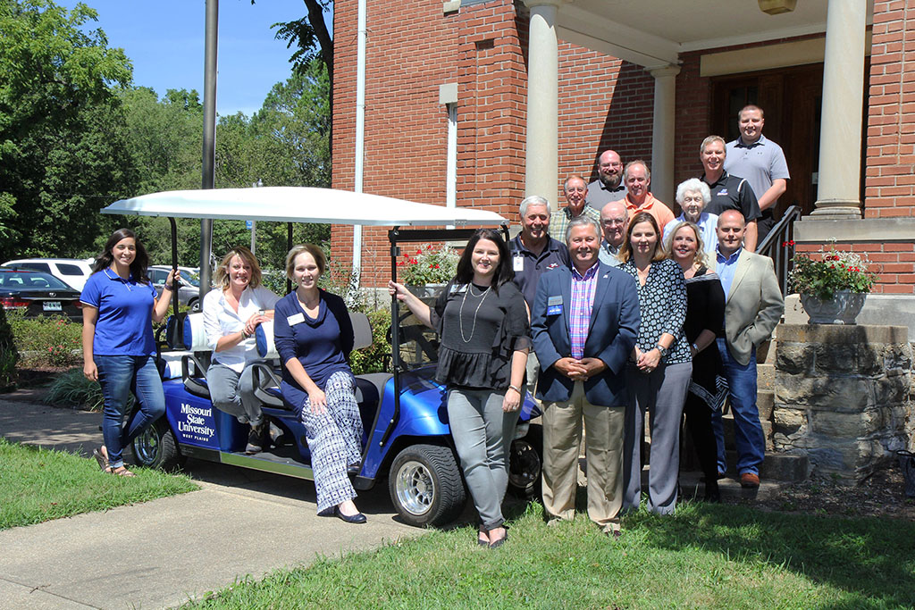 MONEY FROM THE ANNUAL FUND at Missouri State University-West Plains went toward the purchase of this golf cart for campus tours. With the cart are, front row from left, Student Ambassador Lekisha Hernandez, Dadeville; Development Board member Sonja Stauffer; Dean of Student Services Dr. Angela Totty; Recruitment Specialist Rachel Peterson; Chancellor Drew Bennett; and board member Melissa Stewart. Second row: Board member Jack Bates, emeritus board director Paul Childers; and board members Karen Smith and Erik Montgomery. Third row: Board president Danny James, board member John Grisham and emeritus board director Jeanette Grisham. Fourth row: Board member Richard Davidson and Director of Development Joe Kammerer. Back row: Board member Dakota Bates. (Missouri State-West Plains Photo)