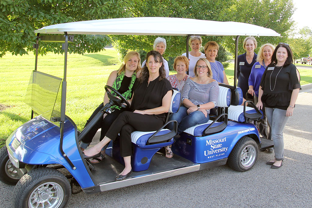 THE PHILANTHROPIC WOMEN FOR EDUCATION (PWE) recently donated funds for the purchase of this golf cart for the admissions office at Missouri State University-West Plains. The cart will be used for campus tours, among other uses, university officials said. Front row from left: PWE members Mary-Louise Tollenaar, Emily Grisham, Joyce McGee and Jessica Nease. Back row: PWE members Sandra Joplin, Elizabeth Bennett and Regina Gleghorn, Dean of Student Services Dr. Angela Totty, Coordinator of Admissions Melissa Jett and Recruitment Specialist Rachel Peterson. (Missouri State-West Plains Photo)