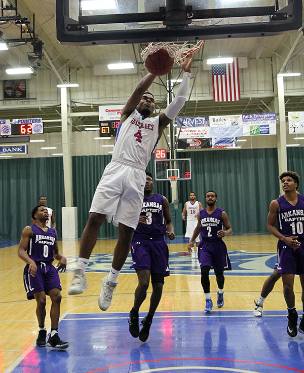 FRESHMAN GUARD ERIC LOVETT brought out the cheers from Grizzly fans on this dunk during the Nov. 21 game against Arkansas Baptist College at the West Plains Civic Center. Lovett had 14 points for the evening. (Missouri State-West Plains Photo)