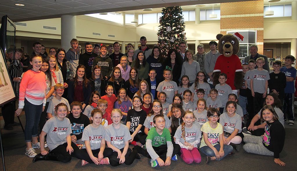 DOZENS OF STUDENTS, faculty, staff and community members gathered Tuesday, Dec. 5, in the lobby of the Lybyer Technology Center on the Missouri State University-West Plains campus to ring in the holiday season with the annual tree lighting ceremony hosted by the university’s Future Alumni Organization (FAO) student group. Those attending enjoyed holiday songs sung by members of the West Plains Elementary School choir and refreshments, including hot cocoa. The tree was decorated with hand-made ornaments created by members of the university’s various student organizations. (Missouri State-West Plains Photo)