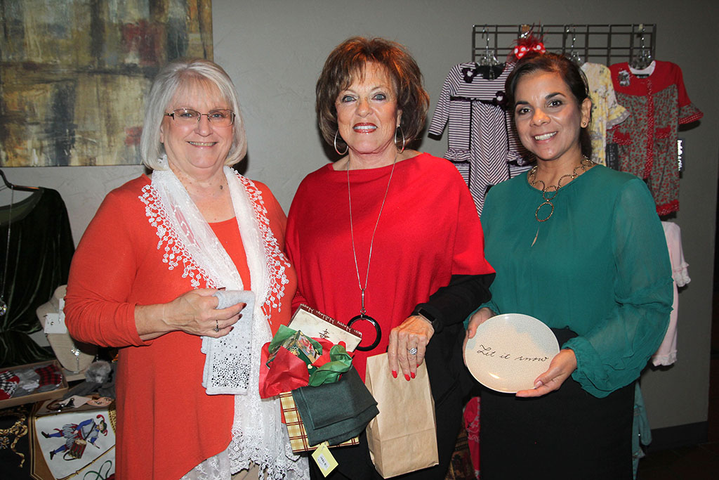 THREE WEST PLAINS RESIDENTS won giveaways at the Friends of the Garnett Library’s annual fall fashion show fundraiser Friday, Nov. 17, at the West Plains Country Club, which was hosted by The Kloz Klozet and Cleea’s At Home Market. From left, Sally Watkins received fingerless gloves from The Kloz Klozet, Linda Gould received a gift basket of various items including Sweet Tooth candy, and Danette Albino received a Christmas plate from Cleea’s At Home Market. Proceeds from the event will go toward ongoing needs at the Garnett Library. (Missouri State-West Plains Photo)