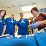 Nursing students learn how to prepare an IV.