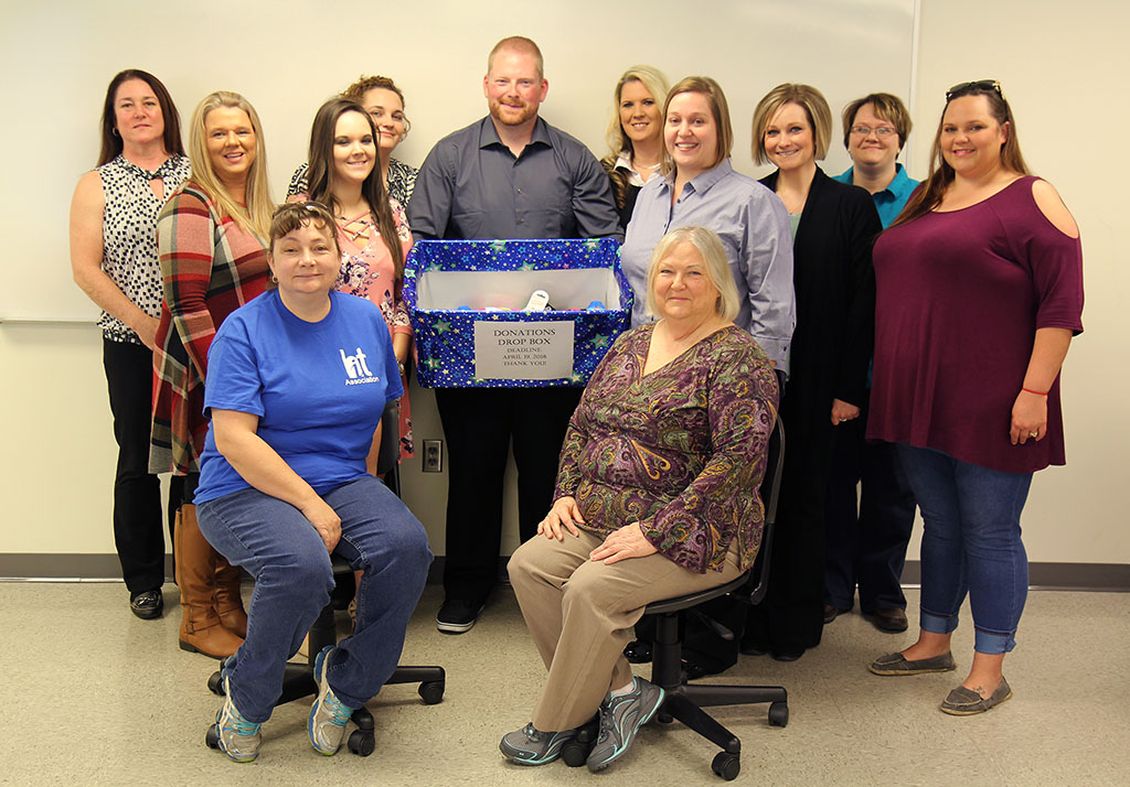 HIT ASSOCIATION MEMBERS already have collected several items for area Head Start students. With those items above are, seated from left, Cynthia Howell, West Plains, and Paula Simandl, Willow Springs. Second row: Jody Nix, West Plains; Josie Hanson, Mountain View; and Melissa Palmer, Sarah Counts and Tosha Gransee, all of West Plains. Back row: Faculty advisor Carla Neff; Stephanie Randall, Jordan Ast (holding box) and Kenna Belcher, all of West Plains; and faculty advisor Tresa Ryan. (Missouri State-West Plains Photo)