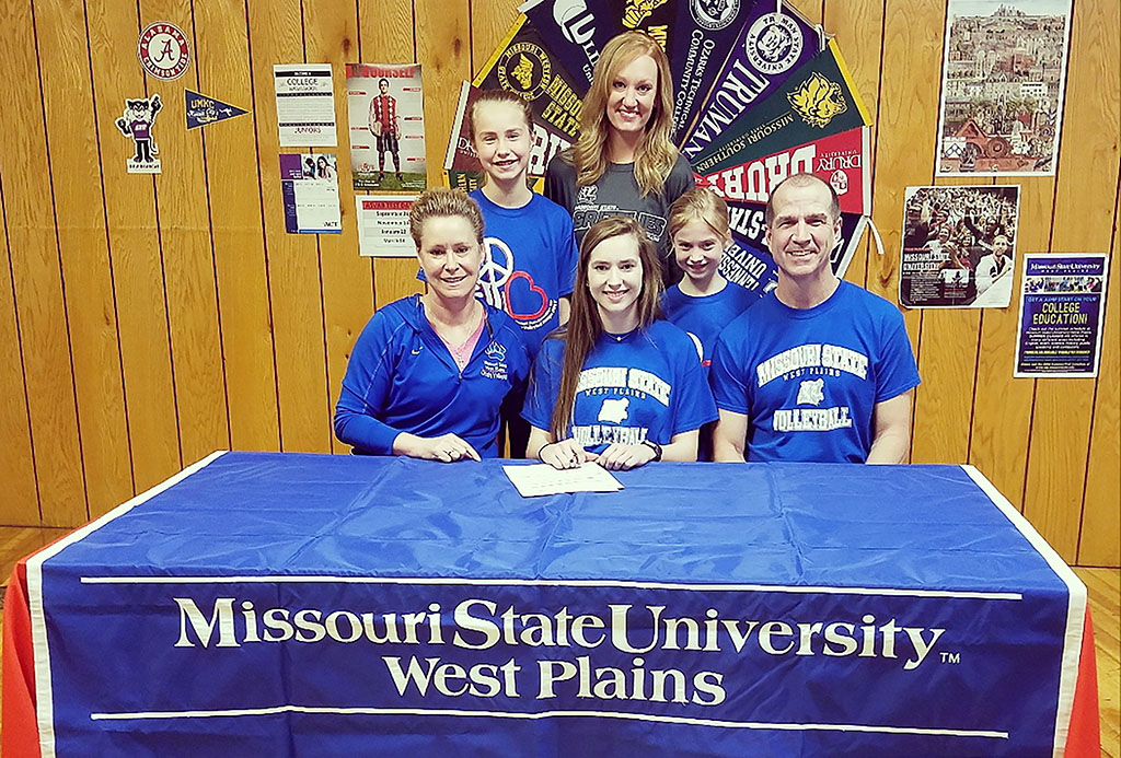 On hand for the signing were, seated from left, Paula, Kelly and her father, Warren Wiedemann. Standing behind, from left, are Kelly’s sister, Lily; Grizzly Volleyball Assistant Coach Briana Walsh; and Kelly’s sister, Emma. (Photo provided)