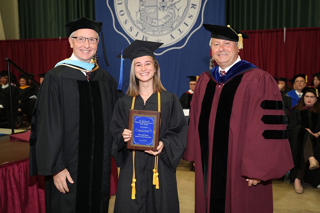 MADISON WIEHE, West Plains, and Amanda Jones, Licking, both received the Outstanding Student Award for Associate of Arts/Associate of Science/Associate of Applied Science degree graduates at Missouri State University-West Plains’ commencement ceremonies Saturday, May 19, at the West Plains Civic Center. The award recognizes a graduate or graduates from either the AA, AS or AAS programs who exhibits academic excellence, interest and enthusiasm in learning, conscientiousness, academic honesty, a willingness to participate and help others in class, and exceptional university and community service. Wiehe graduated with an Associate of Arts in General Studies degree, and Jones graduated with an Associate of Arts in Health Professions degree. From left are Dean of Academic Affairs Dr. Dennis Lancaster, Wiehe and Chancellor Drew Bennett. Jones completed the requirements for her degree during the 2017 fall semester and did not attend Saturday’s ceremony. (Missouri State-West Plains Photo)