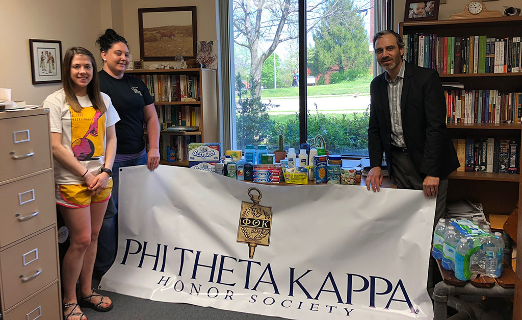 From left are PTK secretary Aimee Metcalf, West Plains, PTK president Keisha Wilson, Licking, and PTK faculty advisor Dr. Jason McCollom with items they collected at the charity poker tournament. (Missouri State-West Plains Photo)