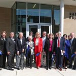 Dignitaries line up outside to cut the ribbon for the Hass-Darr Hall grand opening.