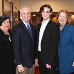 The four stand in a row at a reception on the Springfield campus.