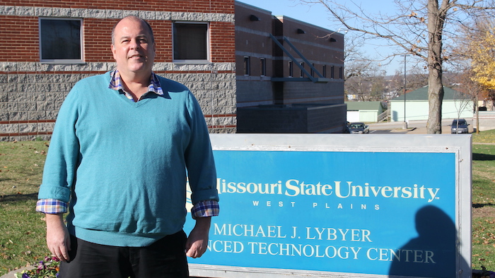 Dr. Birdyshaw outside Lybyer with sign