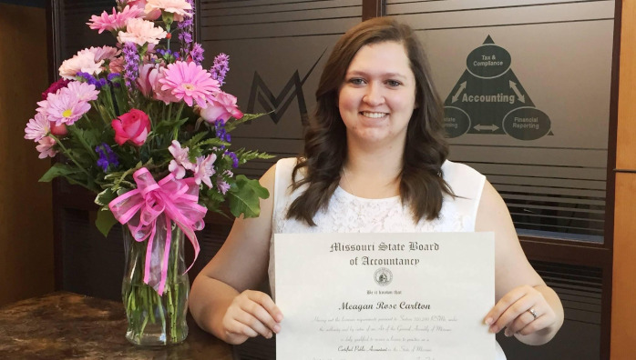 Meagan Carlton poses with certificate and flowers