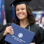Student holds their diploma signifying the finish line
