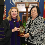 Carol Silvey receives the Granvil Vaughan Founder's Award from Chancellor Zora Mulligan