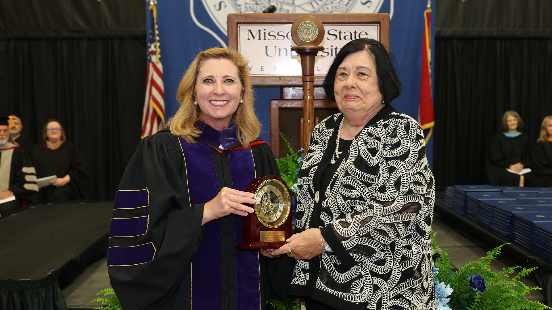 Carol Silvey receives the Granvil Vaughan Founder's Award from Chancellor Zora Mulligan