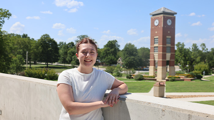 Lydia Davis posed in front of the Smith-London Bell Tower on the West Plains campus